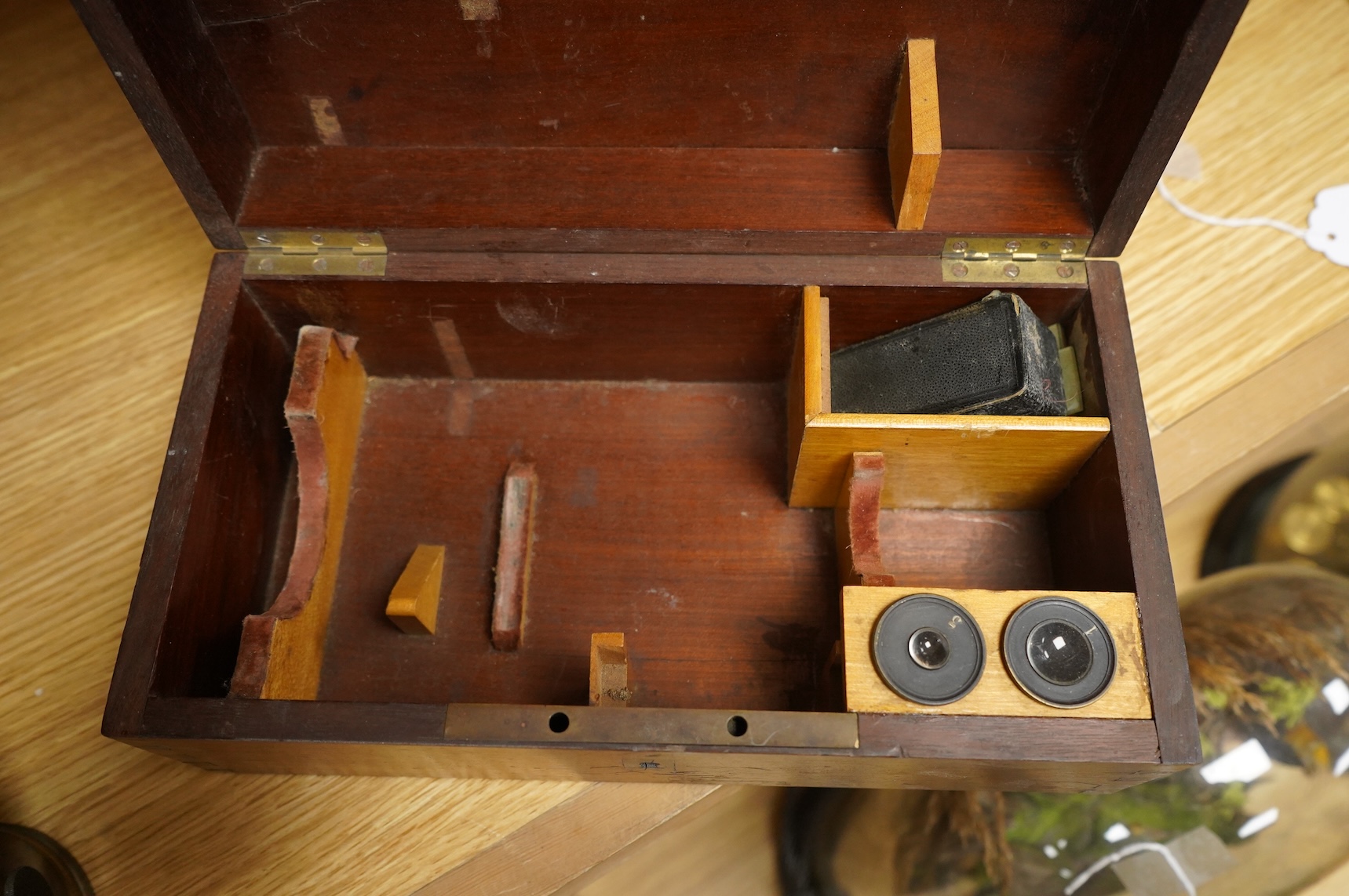 A mid 19th century French brass compound monocular microscope, by Nachet, Optician, Rue Serpente 16, Paris, with two eyepieces, three objectives and several slides, mahogany cased, instrument height 23cm